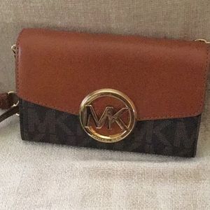 Michael Kors wallet on chair purse